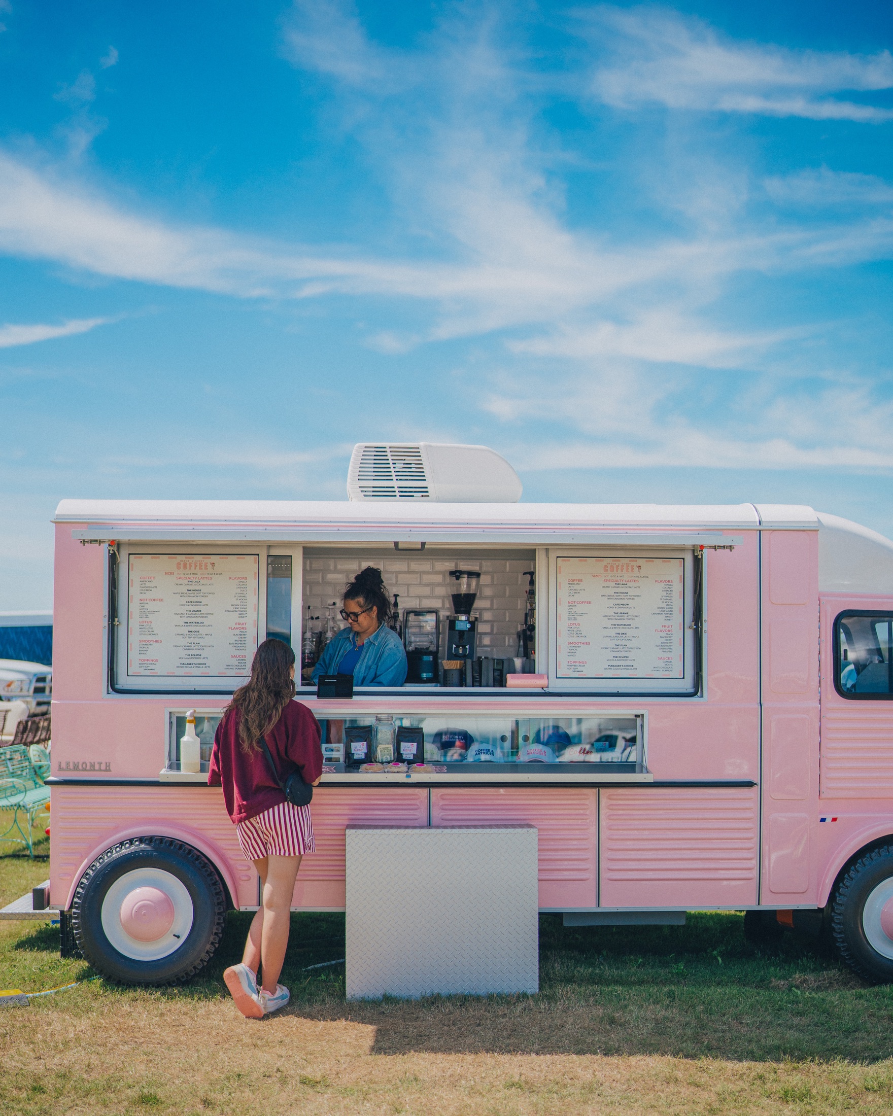 A guest being served from the Maple and Honey pink mobile café