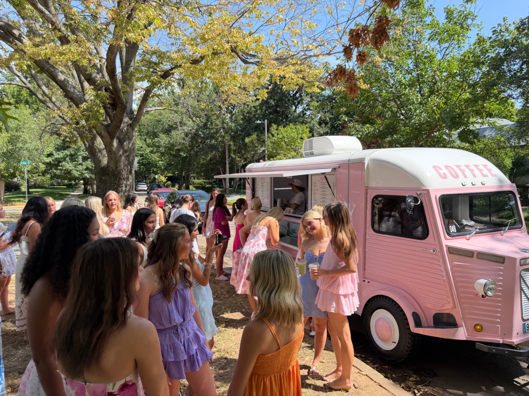Guests gathered around the pink Maple and Honey mobile coffee trailer